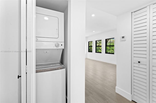 4222 NE 1st Ave, Miami, FL 33137 - washroom featuring stacked washer and clothes dryer, recessed lighting, baseboards, and wood finished floors