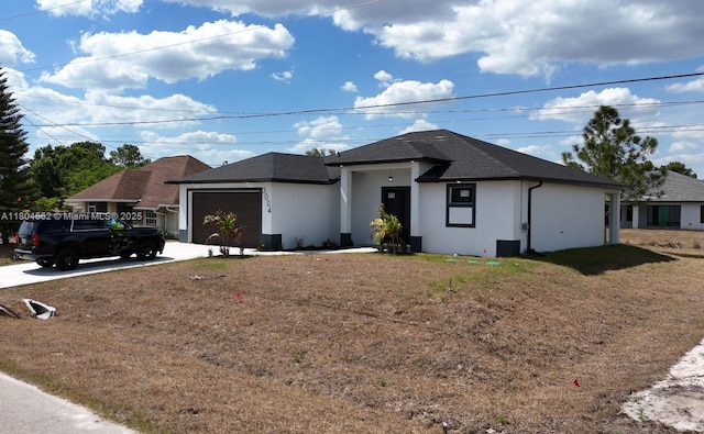 3004 SW 4th St, Lehigh Acres, FL 33976 - view of front of house with driveway, a garage, stucco siding, and a shingled roof