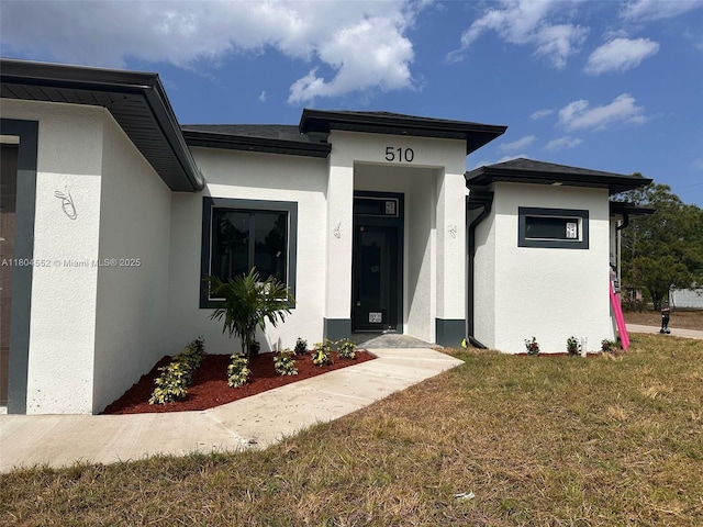 3004 SW 4th St, Lehigh Acres, FL 33976 - view of front of house featuring stucco siding and a front yard