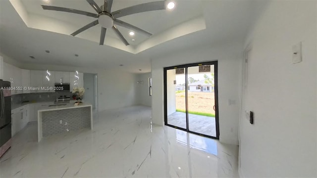 3004 SW 4th St, Lehigh Acres, FL 33976 - kitchen featuring tasteful backsplash, light marble finish floors, white cabinets, a ceiling fan, and recessed lighting