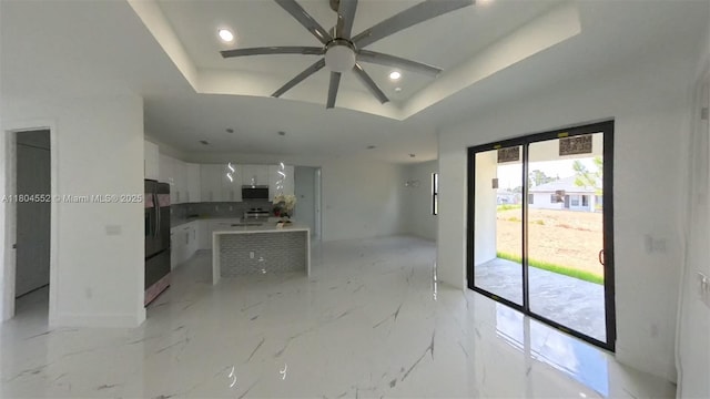 3004 SW 4th St, Lehigh Acres, FL 33976 - unfurnished living room featuring ceiling fan, recessed lighting, a raised ceiling, light marble finish floors, and baseboards
