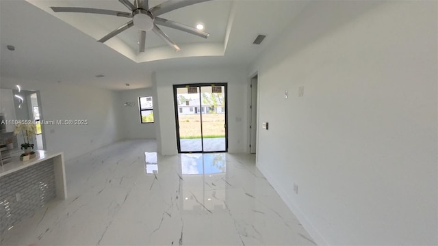 3004 SW 4th St, Lehigh Acres, FL 33976 - spare room featuring a raised ceiling, light marble finish floors, ceiling fan, baseboards, and recessed lighting