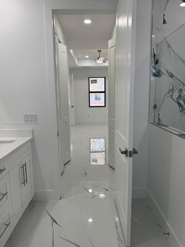 3004 SW 4th St, Lehigh Acres, FL 33976 - bathroom with baseboards, marble finish flooring, recessed lighting, vanity, and a raised ceiling