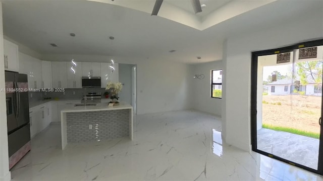 3004 SW 4th St, Lehigh Acres, FL 33976 - kitchen featuring black fridge with ice dispenser, backsplash, white cabinets, modern cabinets, and light marble finish flooring