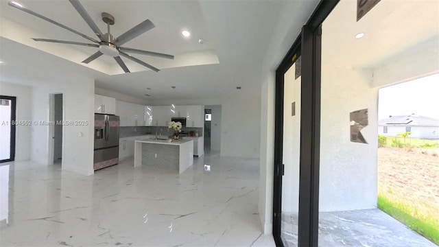 3004 SW 4th St, Lehigh Acres, FL 33976 - kitchen with stainless steel refrigerator with ice dispenser, modern cabinets, white cabinets, a kitchen island, and ceiling fan