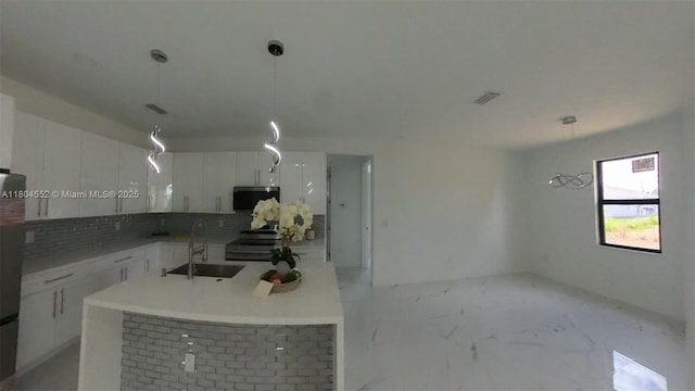 3004 SW 4th St, Lehigh Acres, FL 33976 - kitchen with a sink, decorative backsplash, white cabinets, and stainless steel electric stove