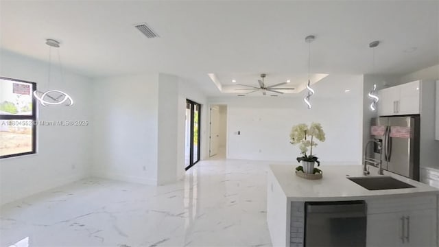 3004 SW 4th St, Lehigh Acres, FL 33976 - kitchen featuring open floor plan, stainless steel fridge with ice dispenser, a sink, white cabinetry, and decorative light fixtures