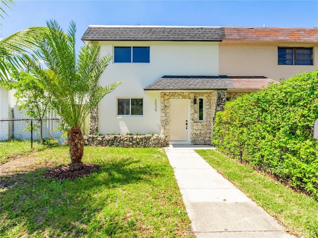 2039 NE 172nd St, North Miami Beach, FL 33162 - view of front of property featuring a shingled roof, stucco siding, and stone siding