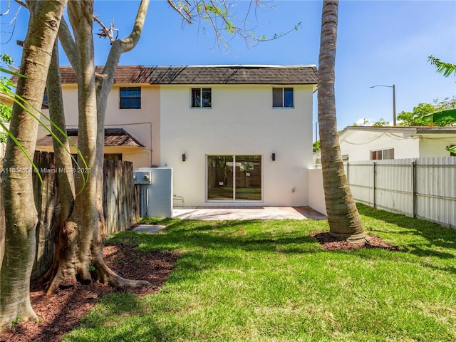 2039 NE 172nd St, North Miami Beach, FL 33162 - rear view of house with stucco siding, a shingled roof, and a patio area