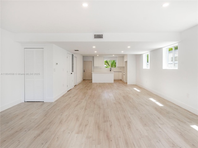2039 NE 172nd St, North Miami Beach, FL 33162 - unfurnished living room featuring baseboards, recessed lighting, and light wood finished floors