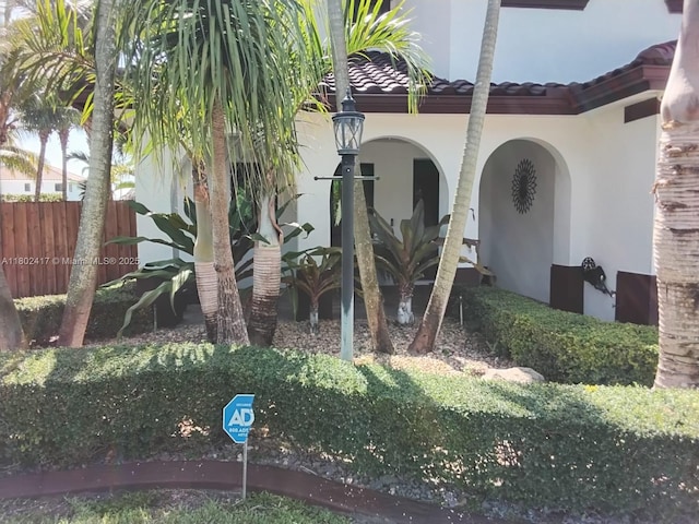 21046 SW 133rd Ct, Miami, FL 33177 - view of exterior entry with stucco siding and a tiled roof
