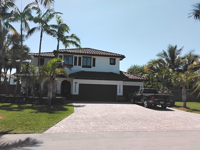 21046 SW 133rd Ct, Miami, FL 33177 - mediterranean / spanish house featuring a tile roof, decorative driveway, a front lawn, and stucco siding