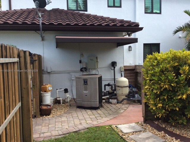 21046 SW 133rd Ct, Miami, FL 33177 - back of property featuring a tiled roof, cooling unit, and stucco siding