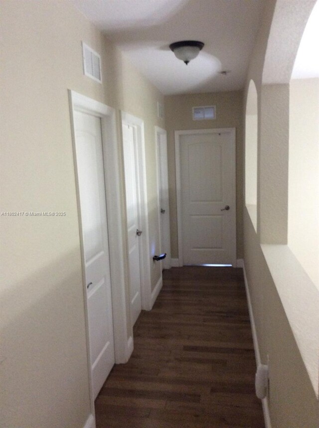21046 SW 133rd Ct, Miami, FL 33177 - hall with arched walkways, wood finished floors, and baseboards