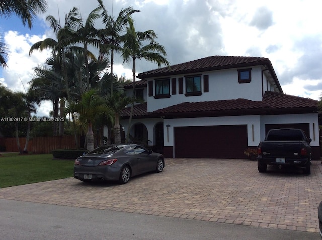 21046 SW 133rd Ct, Miami, FL 33177 - mediterranean / spanish home with decorative driveway, stucco siding, an attached garage, and a tiled roof