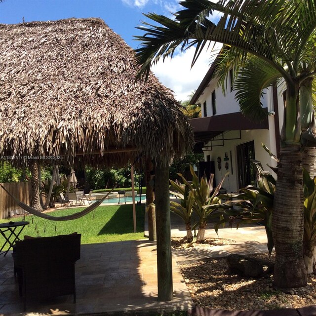 21046 SW 133rd Ct, Miami, FL 33177 - view of green lawn with an outdoor pool and a patio