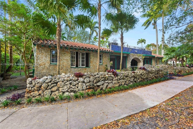 1301 Milan Ave Unit 4, Coral Gables, FL 33134 - view of front of home featuring a tiled roof and stone siding