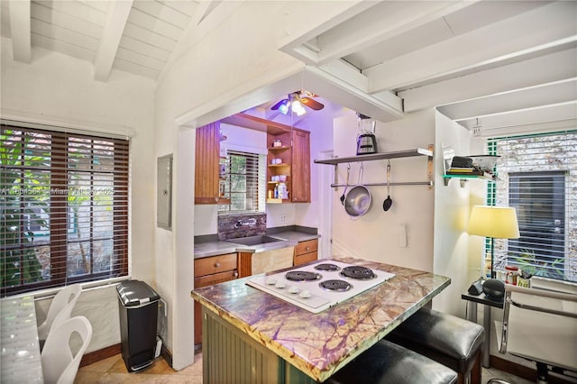 1301 Milan Ave Unit 4, Coral Gables, FL 33134 - kitchen featuring a sink, healthy amount of natural light, white electric cooktop, and brown cabinetry