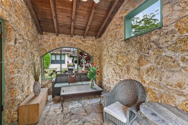 1301 Milan Ave Unit 4, Coral Gables, FL 33134 - living area featuring wooden ceiling, beamed ceiling, stone floors, and high vaulted ceiling