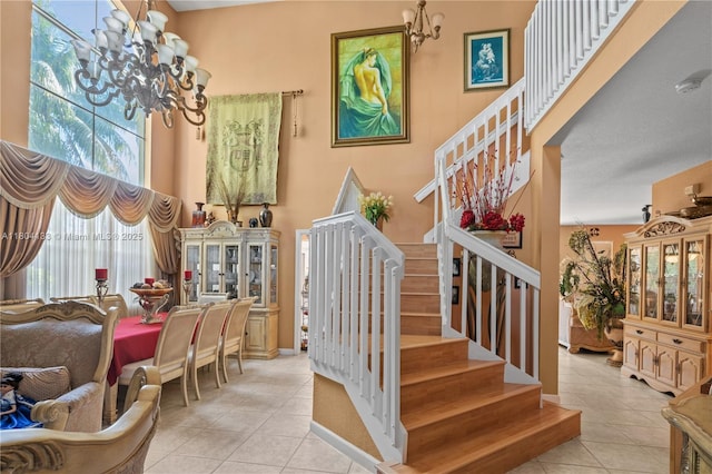 15120 SW 156th Ave, Miami, FL 33196 - stairs with a chandelier, tile patterned flooring, and a towering ceiling