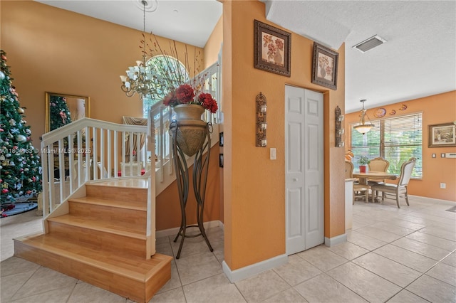 15120 SW 156th Ave, Miami, FL 33196 - stairway featuring tile patterned flooring, a chandelier, and baseboards