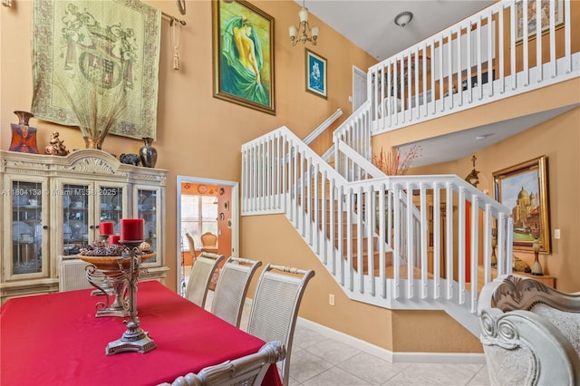 15120 SW 156th Ave, Miami, FL 33196 - tiled dining space with a high ceiling, stairs, and baseboards