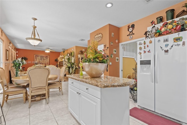 15120 SW 156th Ave, Miami, FL 33196 - kitchen with white refrigerator with ice dispenser, white cabinetry, ceiling fan, hanging light fixtures, and light tile patterned floors