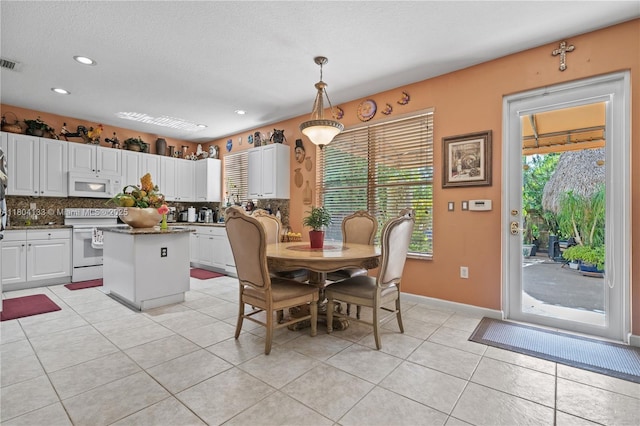 15120 SW 156th Ave, Miami, FL 33196 - dining area with light tile patterned floors, recessed lighting, baseboards, and a textured ceiling