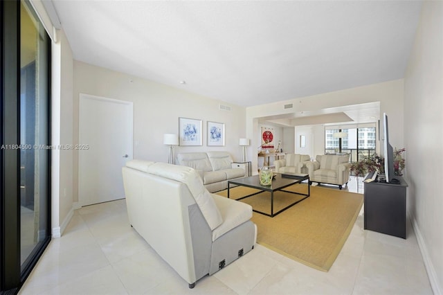 16275 Collins Ave Unit 1202, Sunny Isles Beach, FL 33160 - living room featuring light tile patterned flooring and baseboards