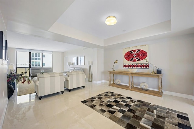 16275 Collins Ave Unit 1202, Sunny Isles Beach, FL 33160 - living area with baseboards, tile patterned floors, and a raised ceiling