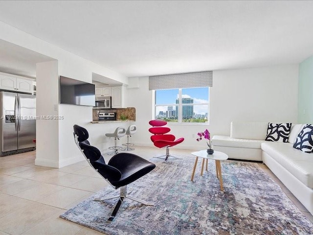 7620 Carlyle Ave Unit 702, Miami Beach, FL 33141 - living room featuring baseboards and light tile patterned floors