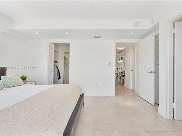7620 Carlyle Ave Unit 702, Miami Beach, FL 33141 - bedroom featuring recessed lighting, a spacious closet, light tile patterned floors, baseboards, and a closet