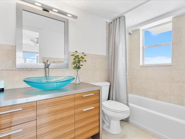 7620 Carlyle Ave Unit 702, Miami Beach, FL 33141 - bathroom featuring tile walls, toilet, vanity, tile patterned flooring, and shower / bath combination with curtain