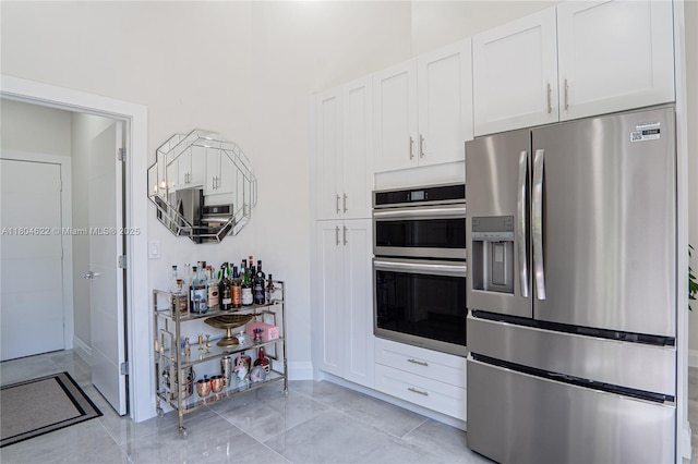 6670 NW 27th Ave, Boca Raton, FL 33496 - kitchen with stainless steel appliances, white cabinetry, and baseboards