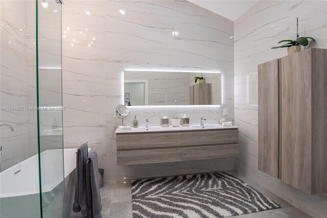 6670 NW 27th Ave, Boca Raton, FL 33496 - bathroom with double vanity, tile walls, and vaulted ceiling