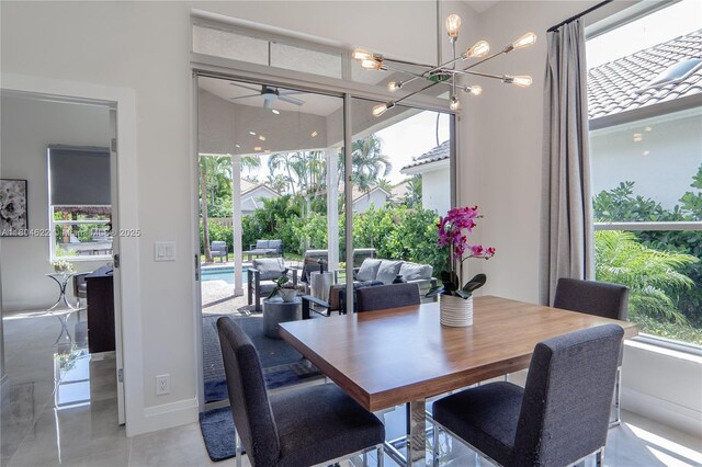 6670 NW 27th Ave, Boca Raton, FL 33496 - dining room with ceiling fan, baseboards, and a chandelier
