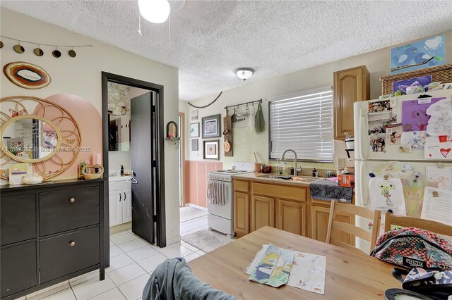 13504 SW 68th Ter, Miami, FL 33183 - kitchen featuring white appliances, a sink, light tile patterned floors, and a textured ceiling