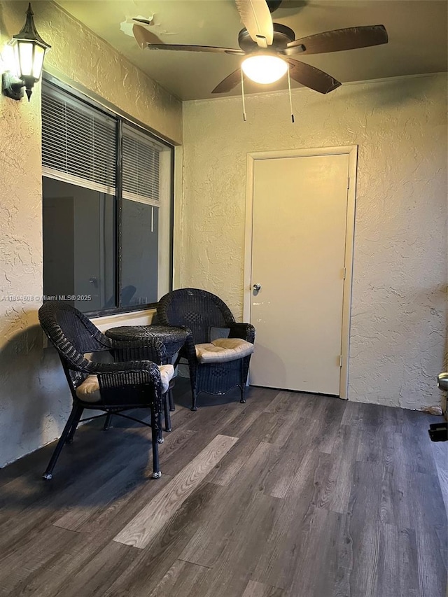 interior space with ceiling fan