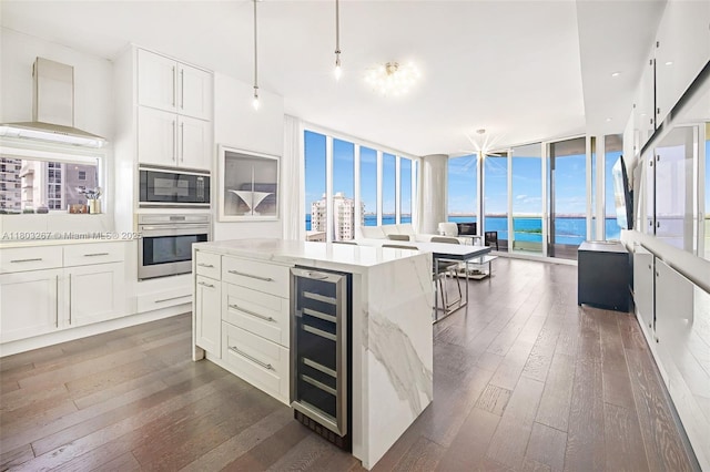 2020 N Bayshore Dr Unit 2001, Miami, FL 33137 - kitchen featuring wine cooler, stainless steel oven, black microwave, dark wood-style floors, and expansive windows