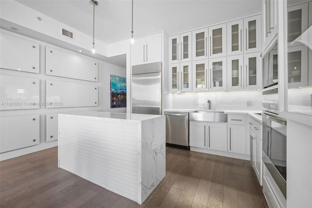 2020 N Bayshore Dr Unit 2001, Miami, FL 33137 - kitchen featuring built in appliances, dark wood-style floors, and white cabinets
