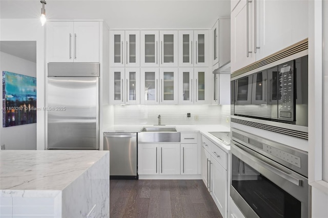 2020 N Bayshore Dr Unit 2001, Miami, FL 33137 - kitchen featuring built in appliances, white cabinetry, dark wood-type flooring, and glass insert cabinets
