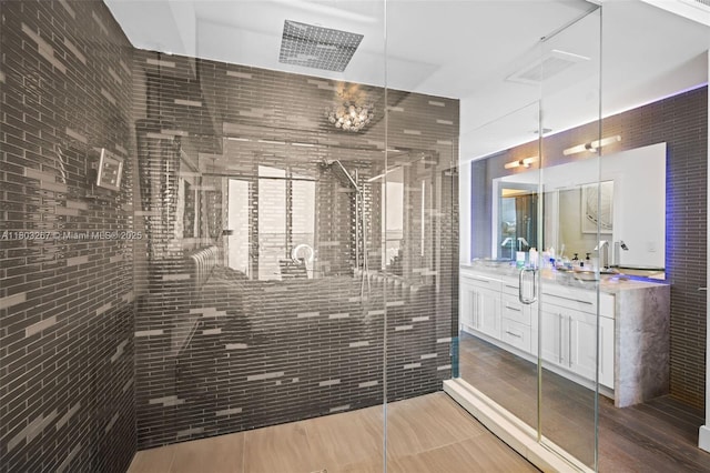 2020 N Bayshore Dr Unit 2001, Miami, FL 33137 - bathroom with vanity, a stall shower, wood finished floors, and a chandelier