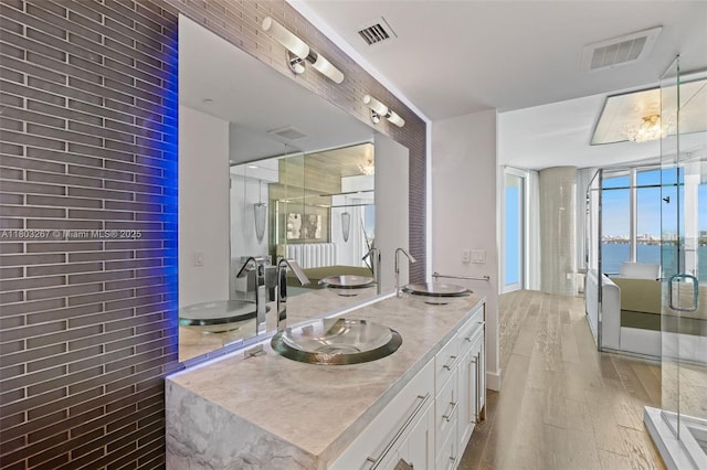 2020 N Bayshore Dr Unit 2001, Miami, FL 33137 - full bathroom featuring wood finished floors, double vanity, and a shower stall
