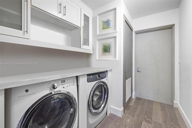 2020 N Bayshore Dr Unit 2001, Miami, FL 33137 - laundry area with washer and dryer, cabinet space, dark wood-style floors, and baseboards