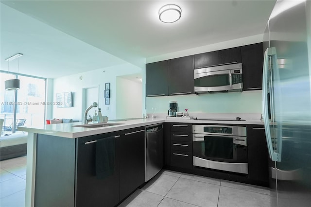 90 SW 3rd St Unit 1401, Miami, FL 33130 - kitchen featuring stainless steel appliances, a peninsula, a sink, and light countertops