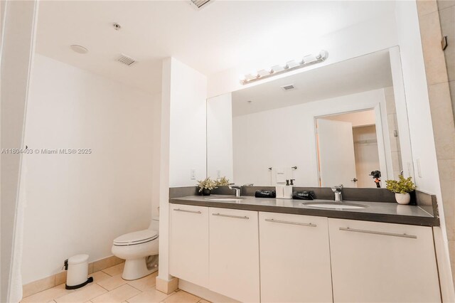 90 SW 3rd St Unit 1401, Miami, FL 33130 - bathroom featuring tile patterned floors, toilet, and double vanity