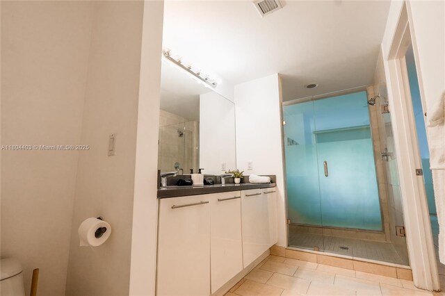 90 SW 3rd St Unit 1401, Miami, FL 33130 - bathroom with a stall shower, vanity, toilet, and tile patterned flooring