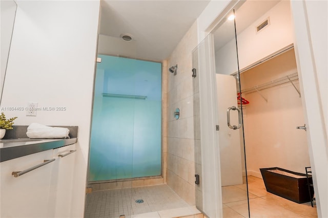 90 SW 3rd St Unit 1401, Miami, FL 33130 - full bath featuring a shower stall, tile patterned flooring, a walk in closet, and a sink