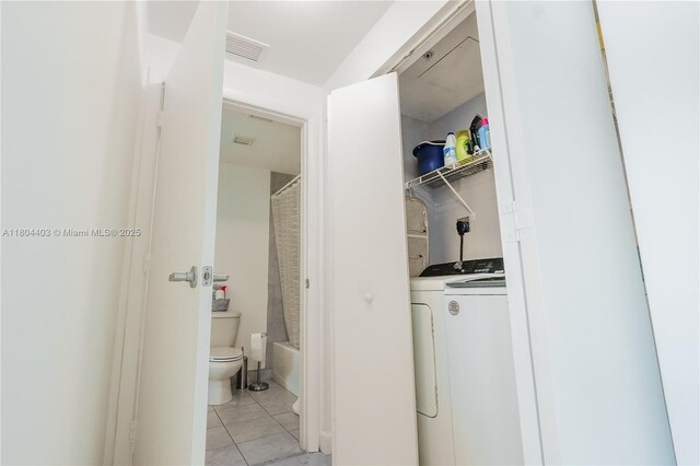 90 SW 3rd St Unit 1401, Miami, FL 33130 - clothes washing area with washer / clothes dryer and light tile patterned floors