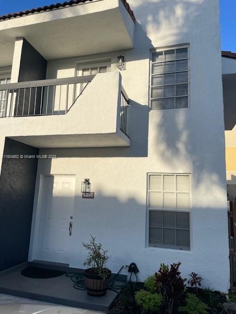 8340 NW 8th St Unit N12, Miami, FL 33126 - view of home's exterior featuring a balcony and stucco siding